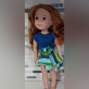 American Girl Willie Wishers doll with blue and green dress and red-brown hair